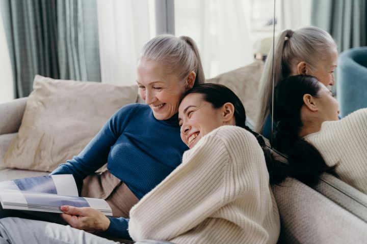 Elderly Woman and Young Woman Laughing Together